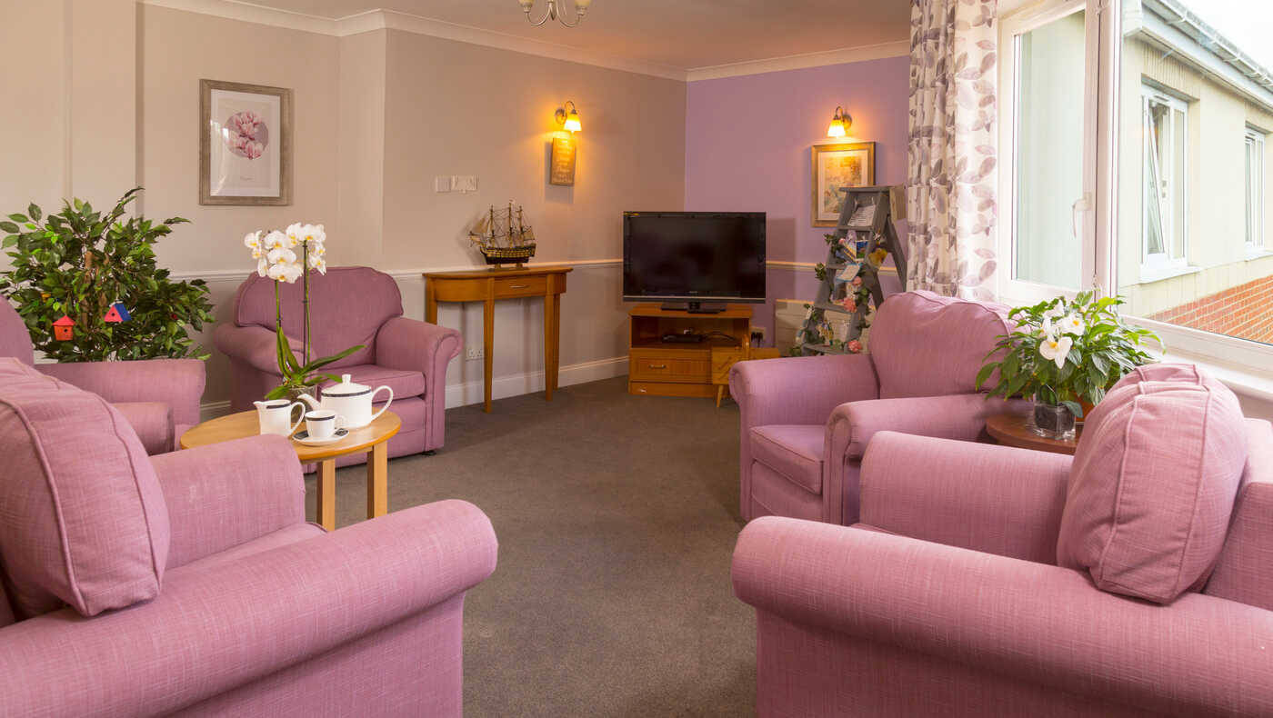 Cozy common area with pink chairs and plants