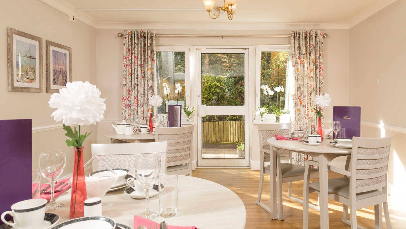 Dining room setup with flowers and table settings