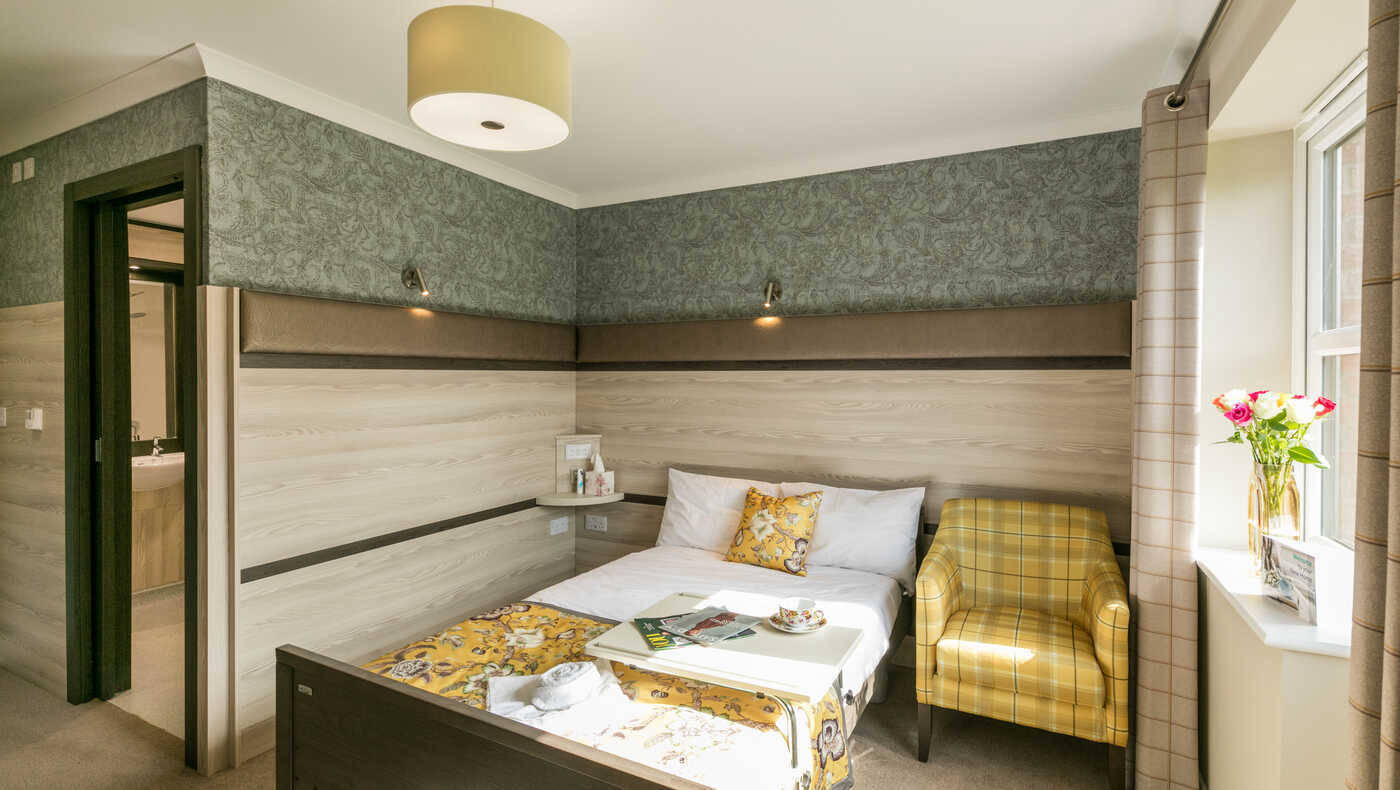 Cozy single resident room with warm decor
