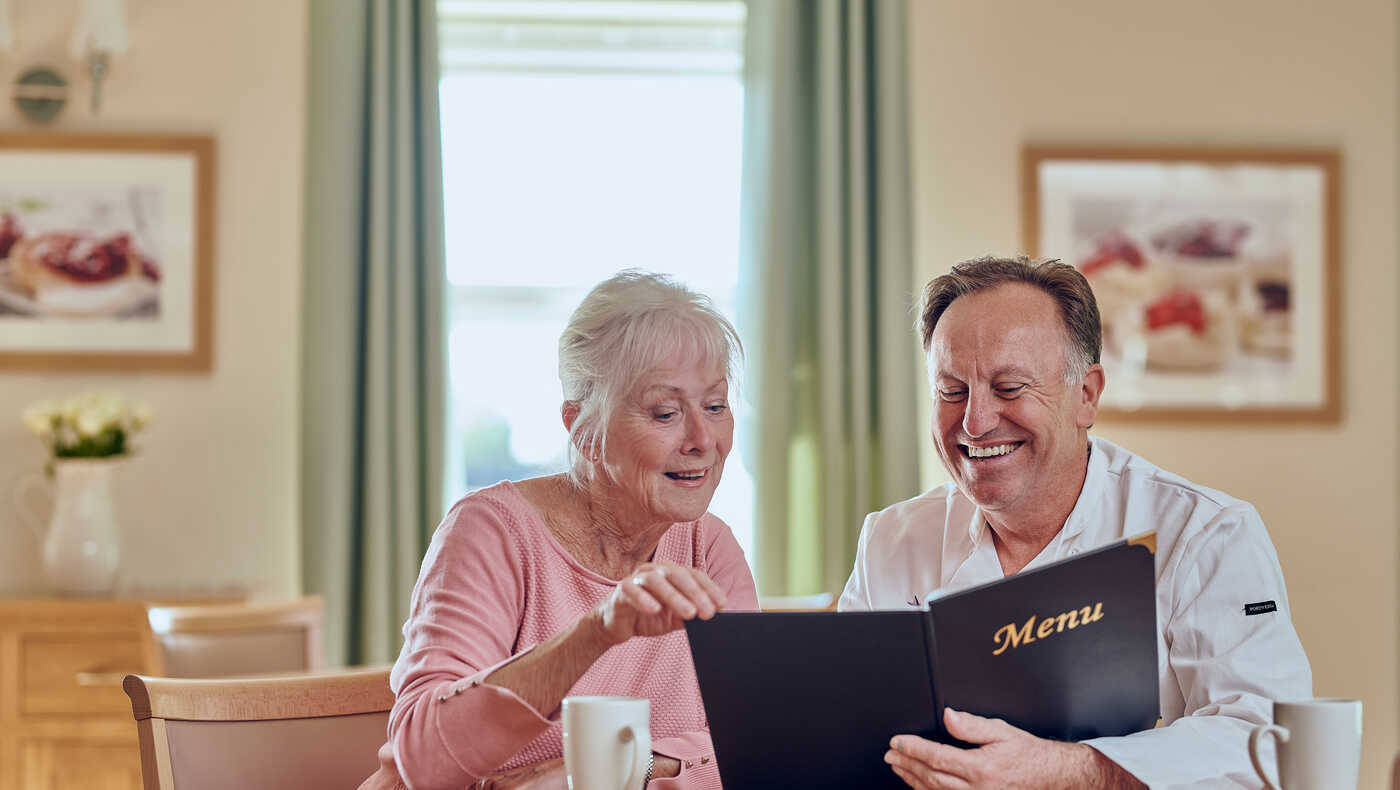 Residents reviewing the menu in a common area