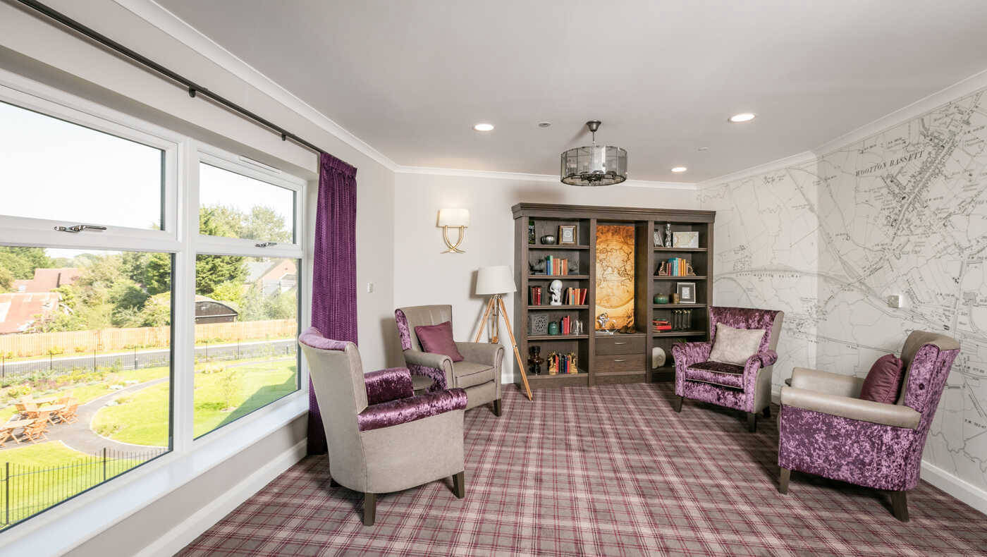 Bright common area with comfortable seating and bookshelves