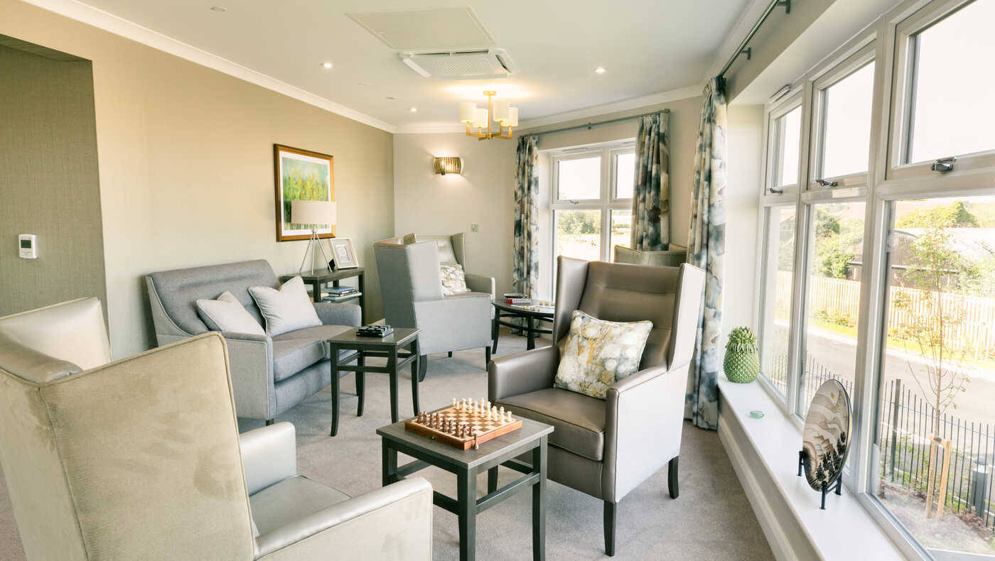 Bright common area with seating and a chessboard