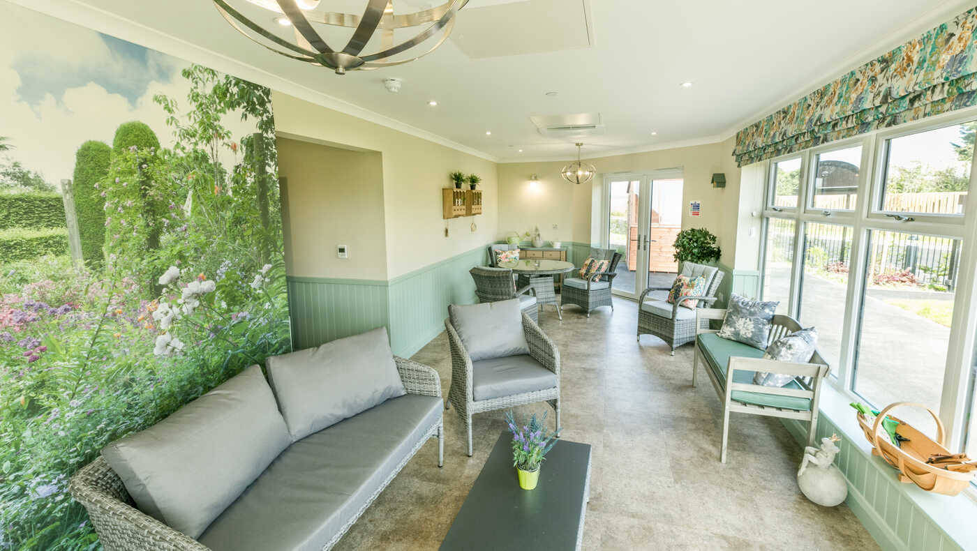 Bright common area with comfortable seating and garden view