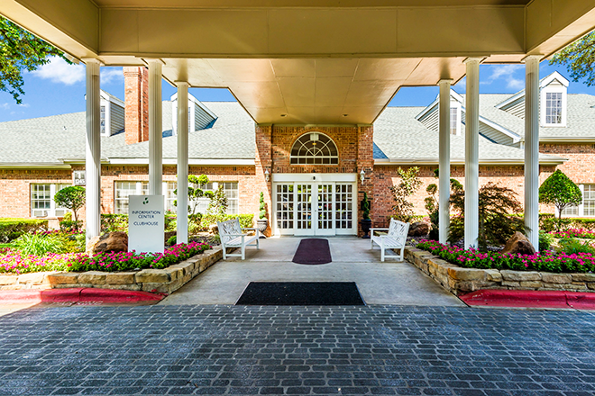 Entrance of a senior living facility with landscaped gardens