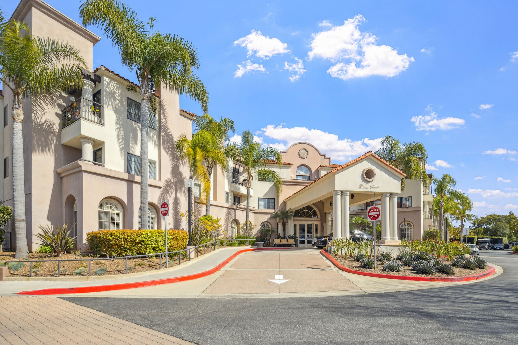 Front entrance of Palm Court by Cogir with landscaped surroundings