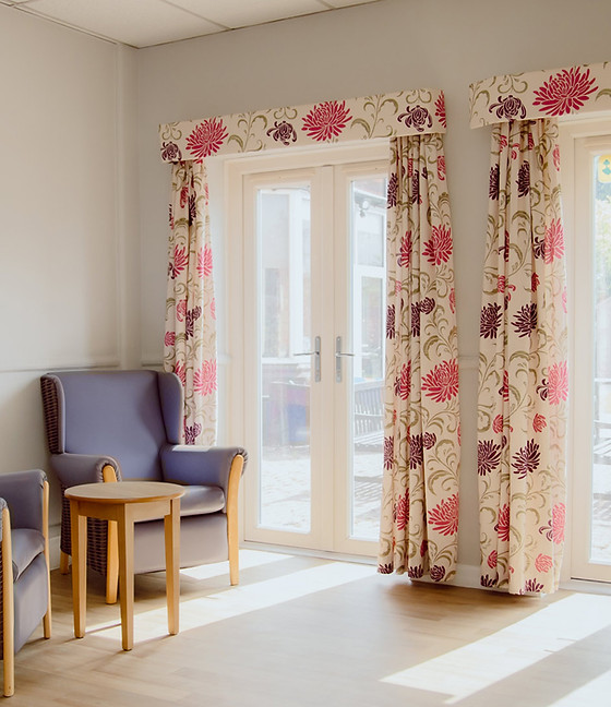 A cozy interior space with floral curtains.