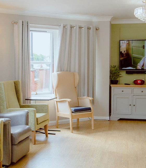 Comfortable interior common area with armchairs and TV