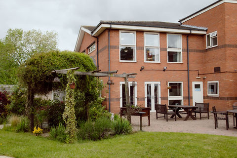 Outdoor patio area with garden and seating