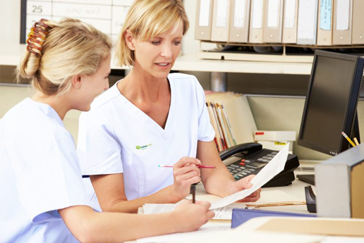 Nursing staff assisting each other with paperwork