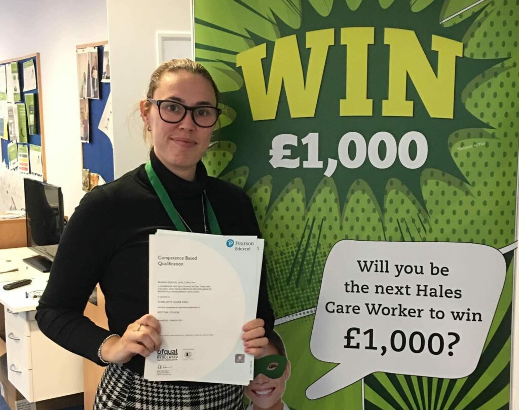 Staff member holding a qualification certificate