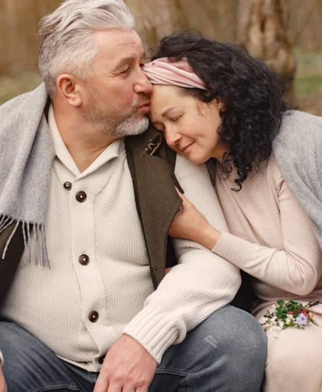 Couple enjoying a tender moment outdoors.