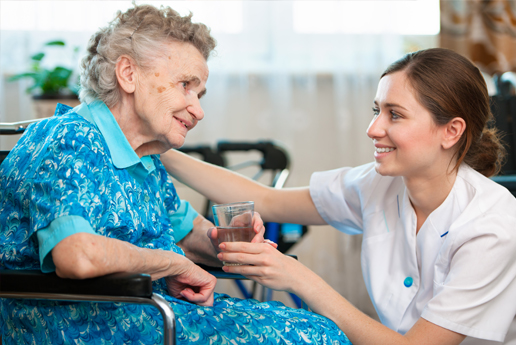 Caregiver assisting a senior resident indoors.