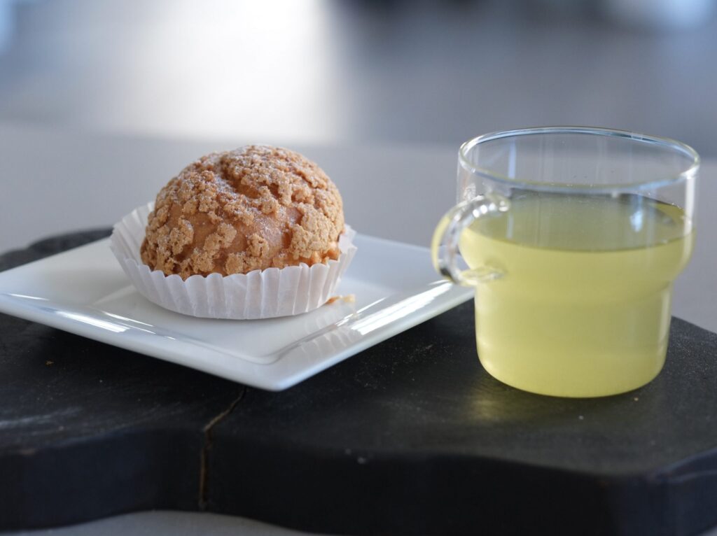 Food item and drink on a white plate and glass