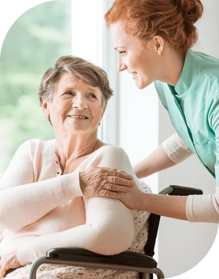 Caregiver interacting with a smiling resident.