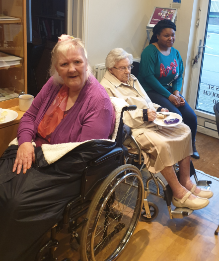 Residents enjoying snacks in a common area.