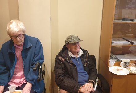 Two elderly residents in a common area.