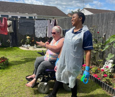 Resident and caregiver enjoying time in the garden