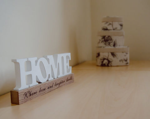 Decorative 'HOME' sign with heartfelt message