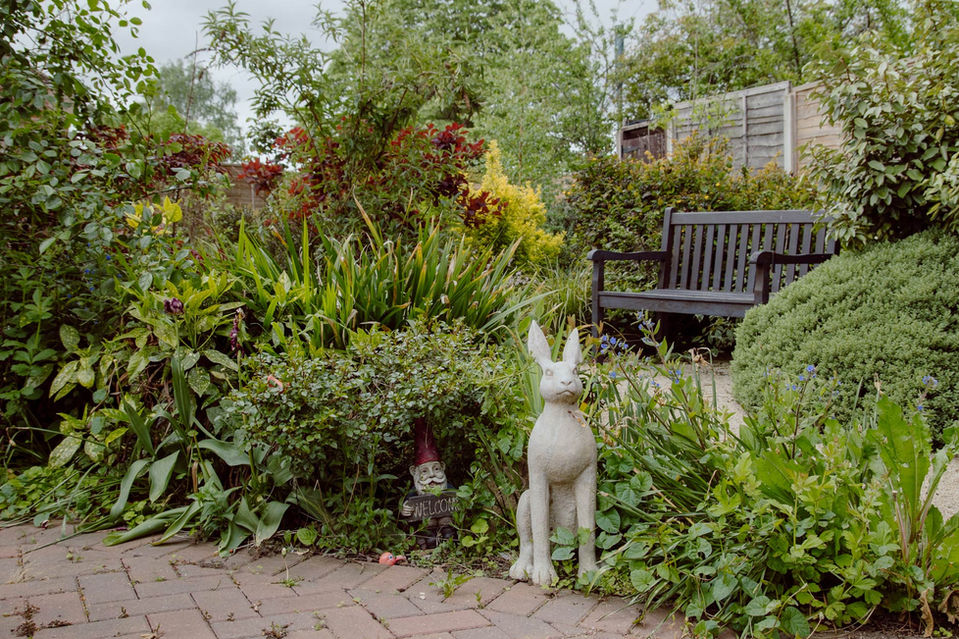 Garden area with seating and decorative statues.