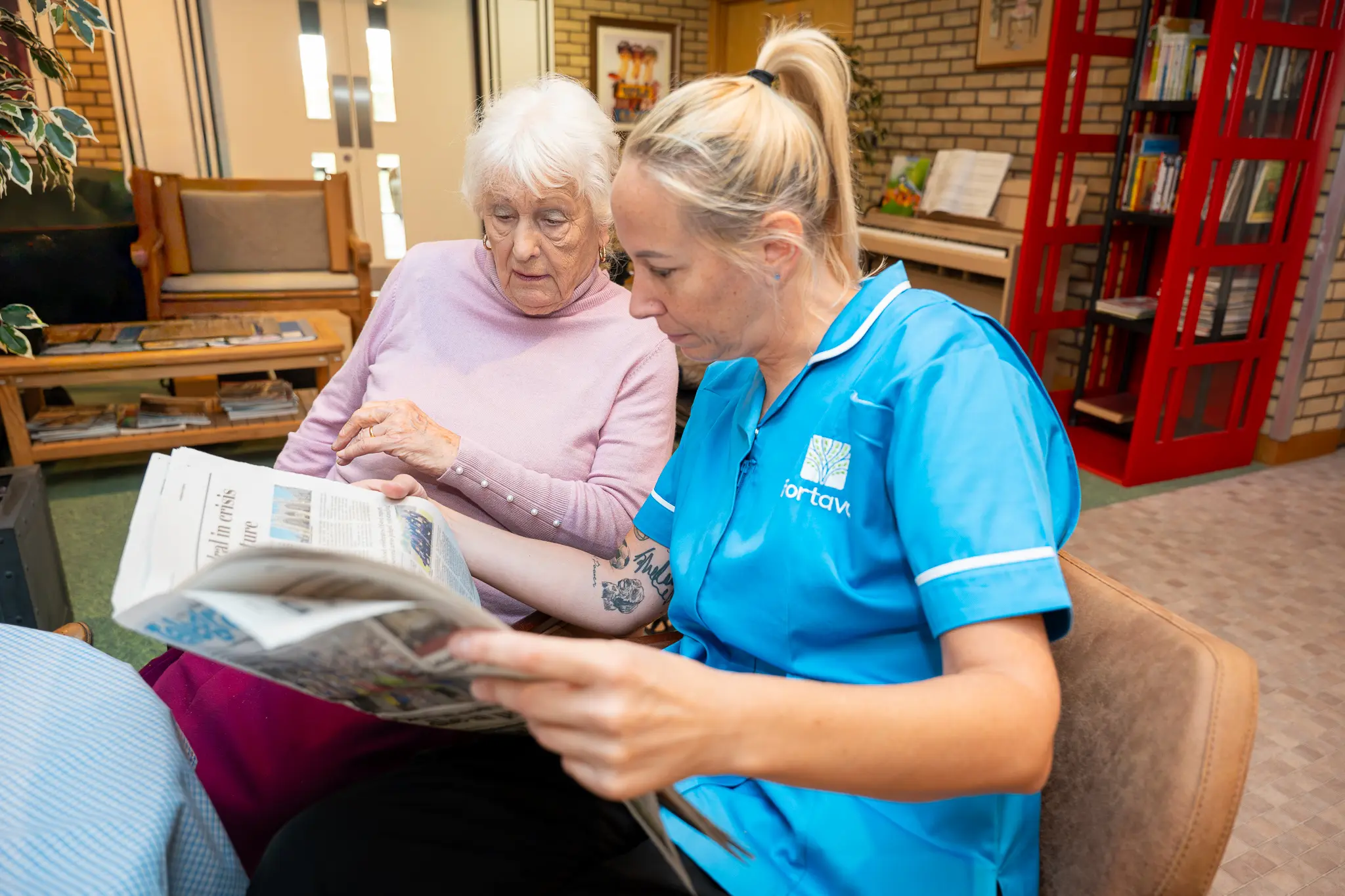 Caregiver assisting resident with reading