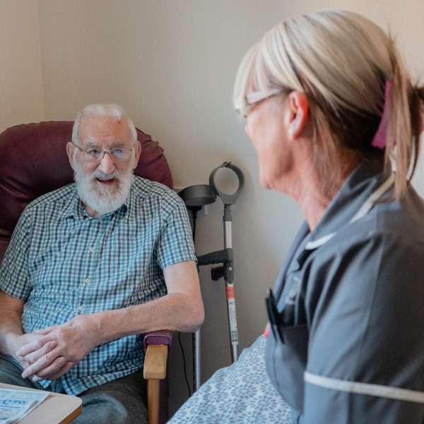 Resident and staff member engaged in conversation