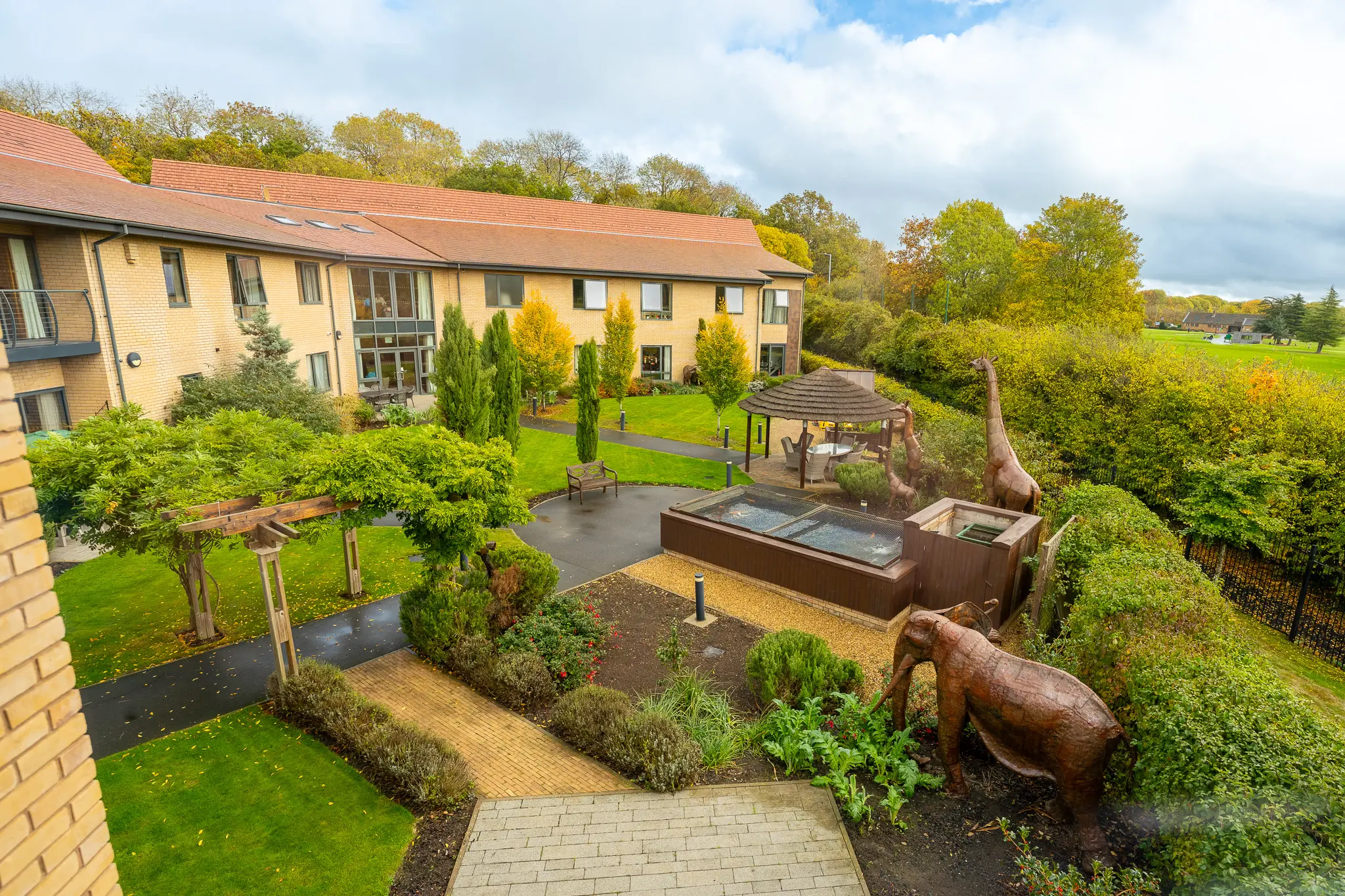Outdoor garden area with sculptures and landscaped spaces.