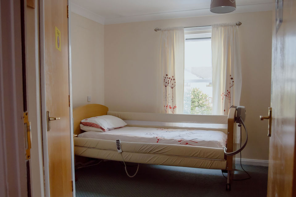 Cozy private room with a hospital bed
