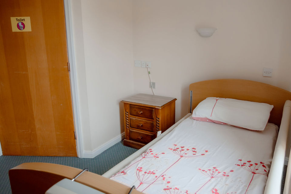 A private resident room with a bed and storage.