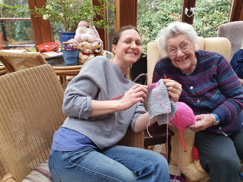 Residents engage in knitting activity together.