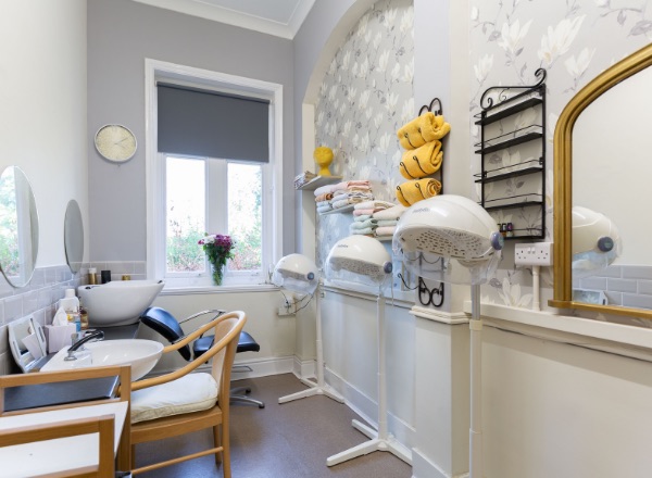 Beauty salon space with hair dryers and towels