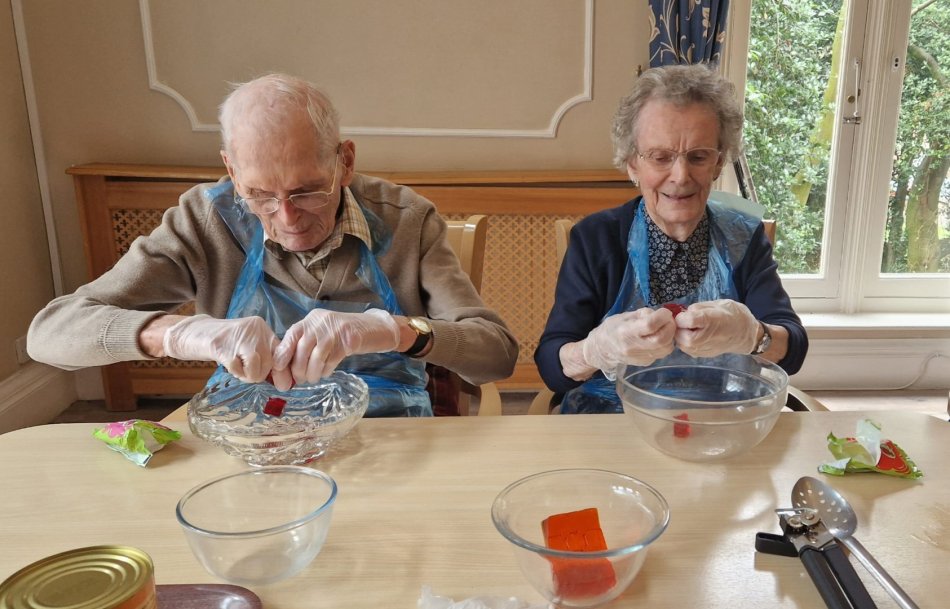 Residents participating in an activity at a table.