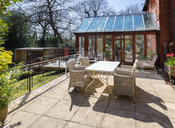 Outdoor patio area with seating and plants