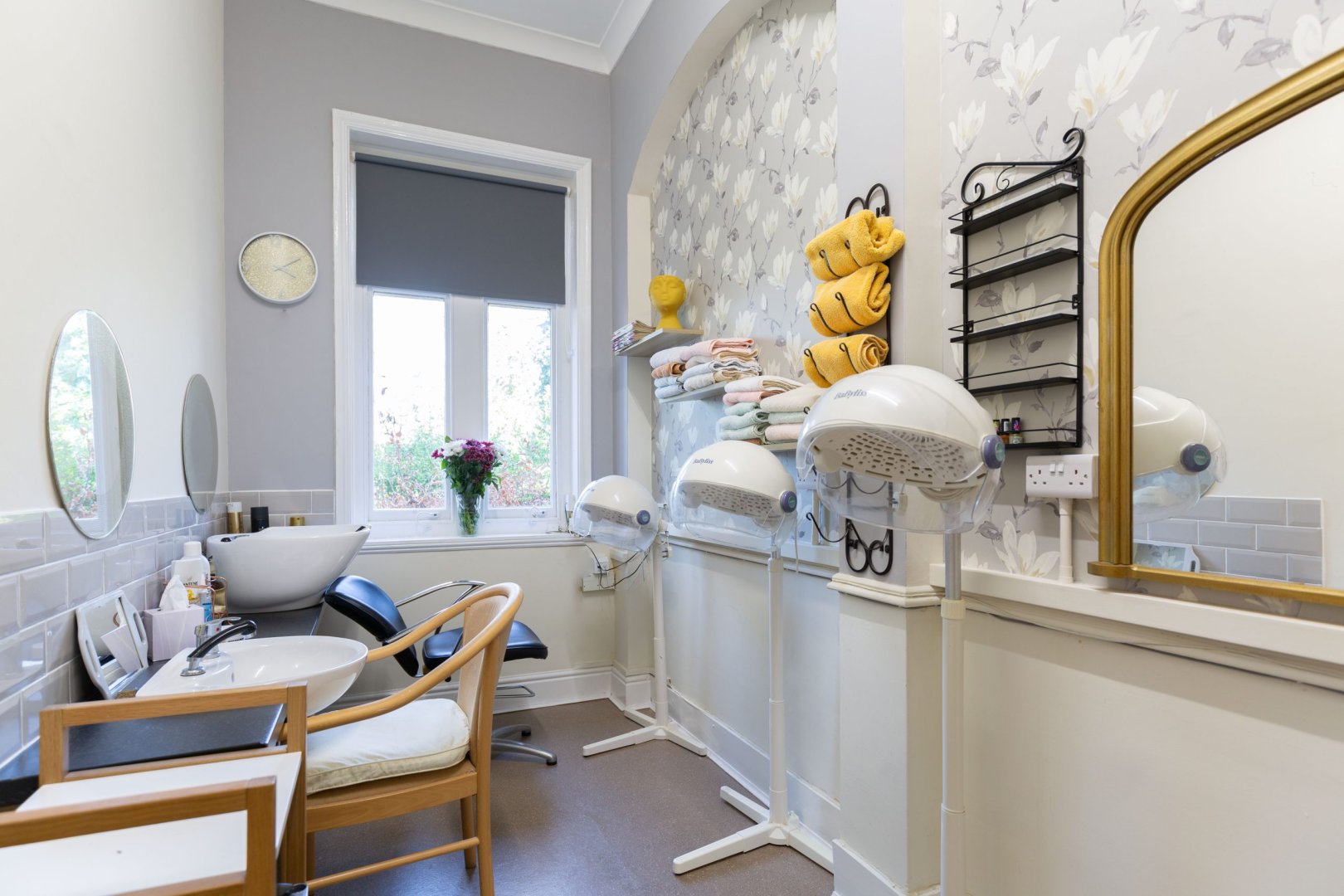 Hair salon area with styling equipment and towels