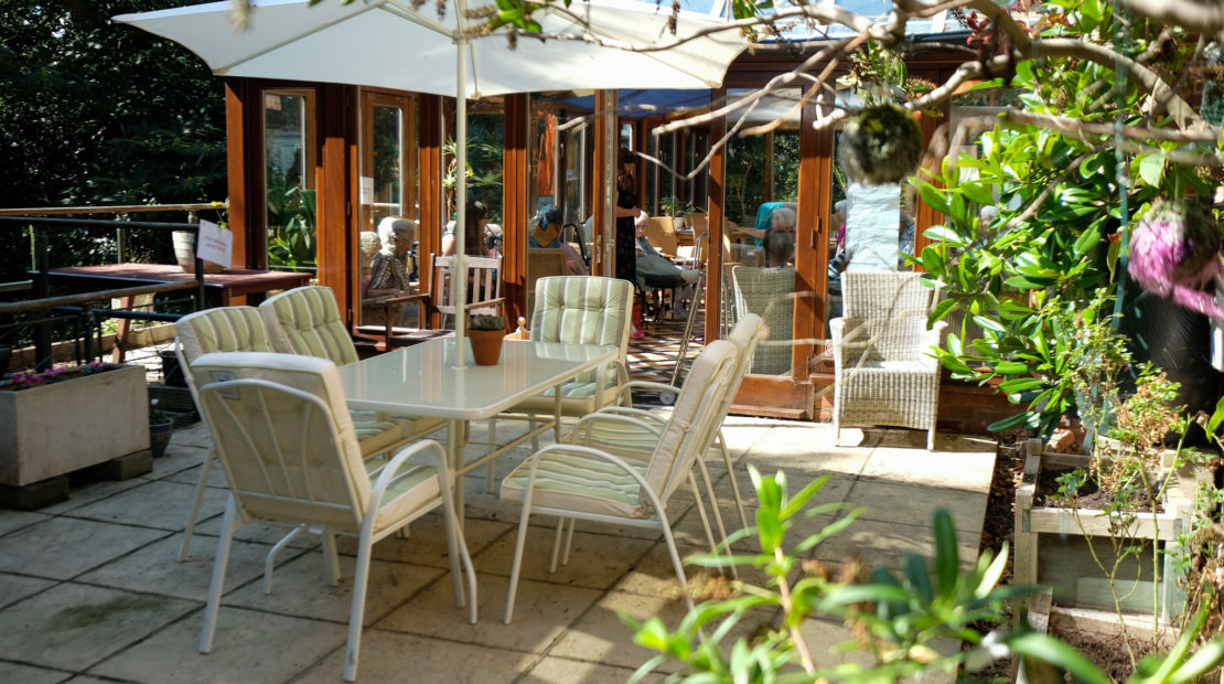 Outdoor seating area with plants and residents
