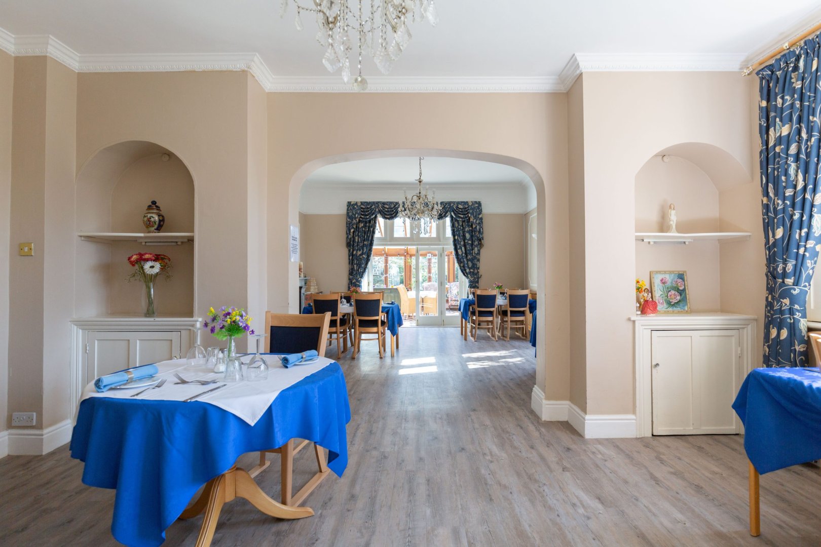 Dining area with blue table settings and natural light.