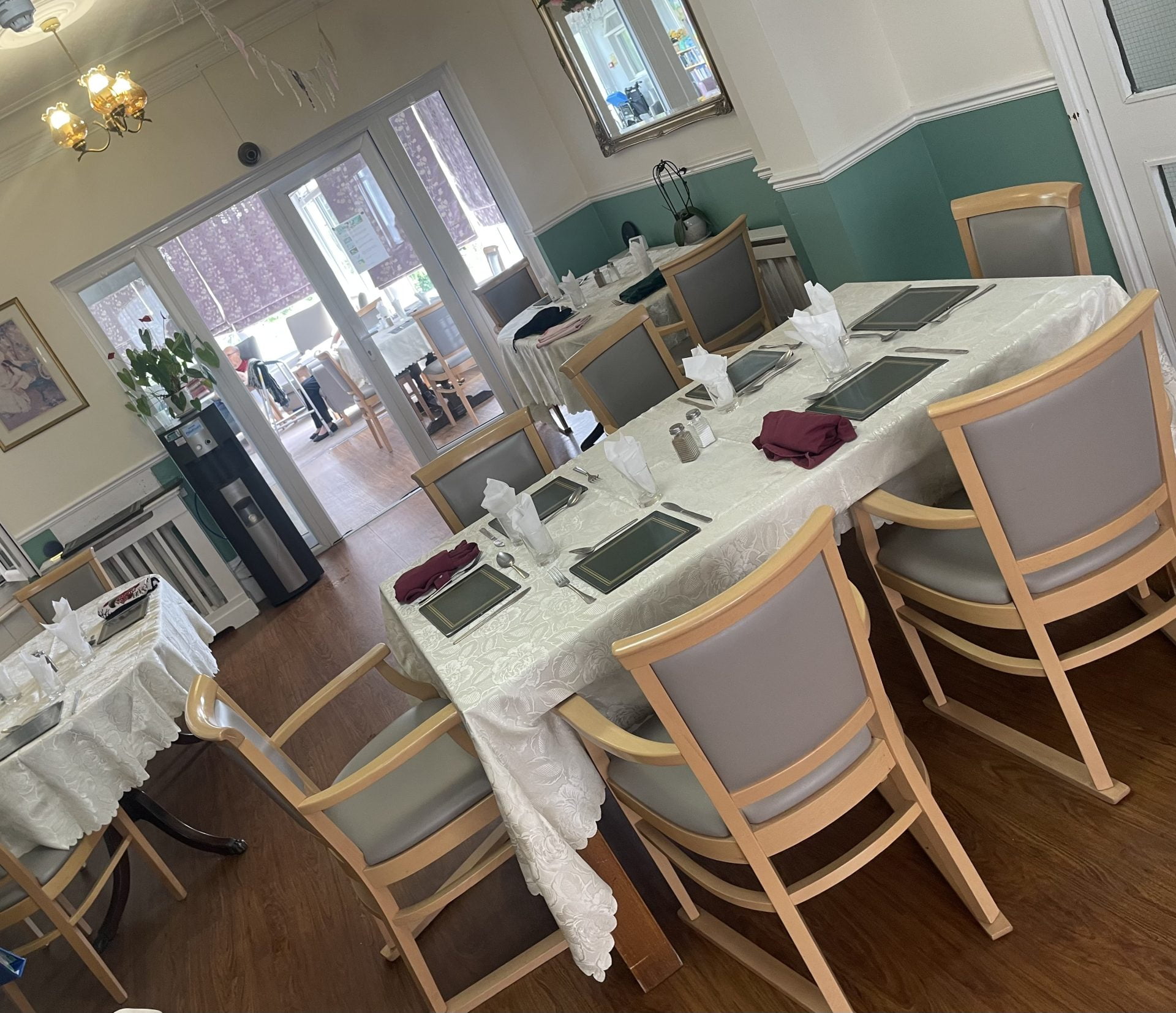 Dining area set for a meal with table settings.