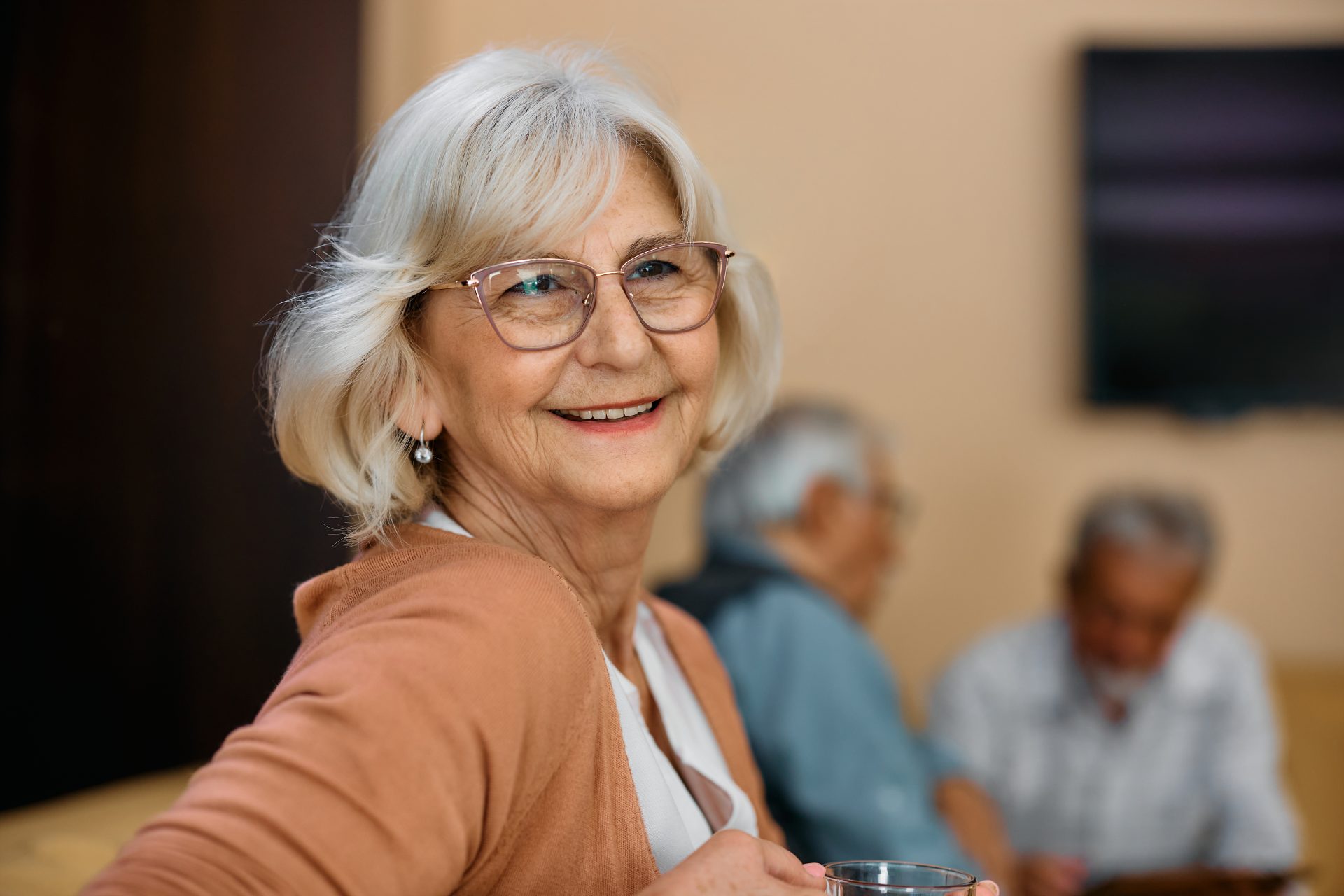 Senior woman smiling in a common area