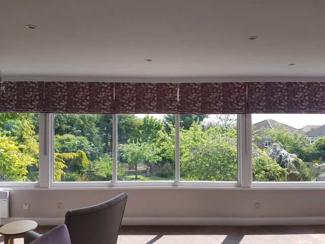 View of a sunny common area with large windows