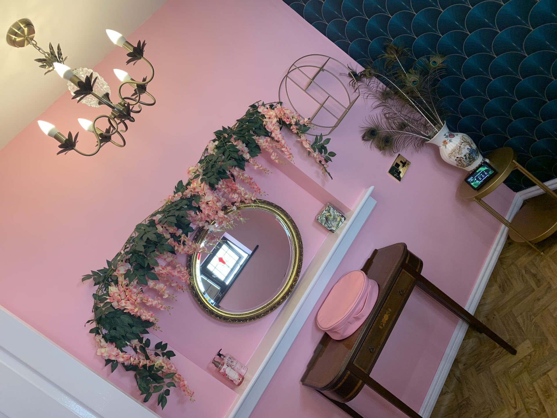 Decorative entryway with plants and chandelier.