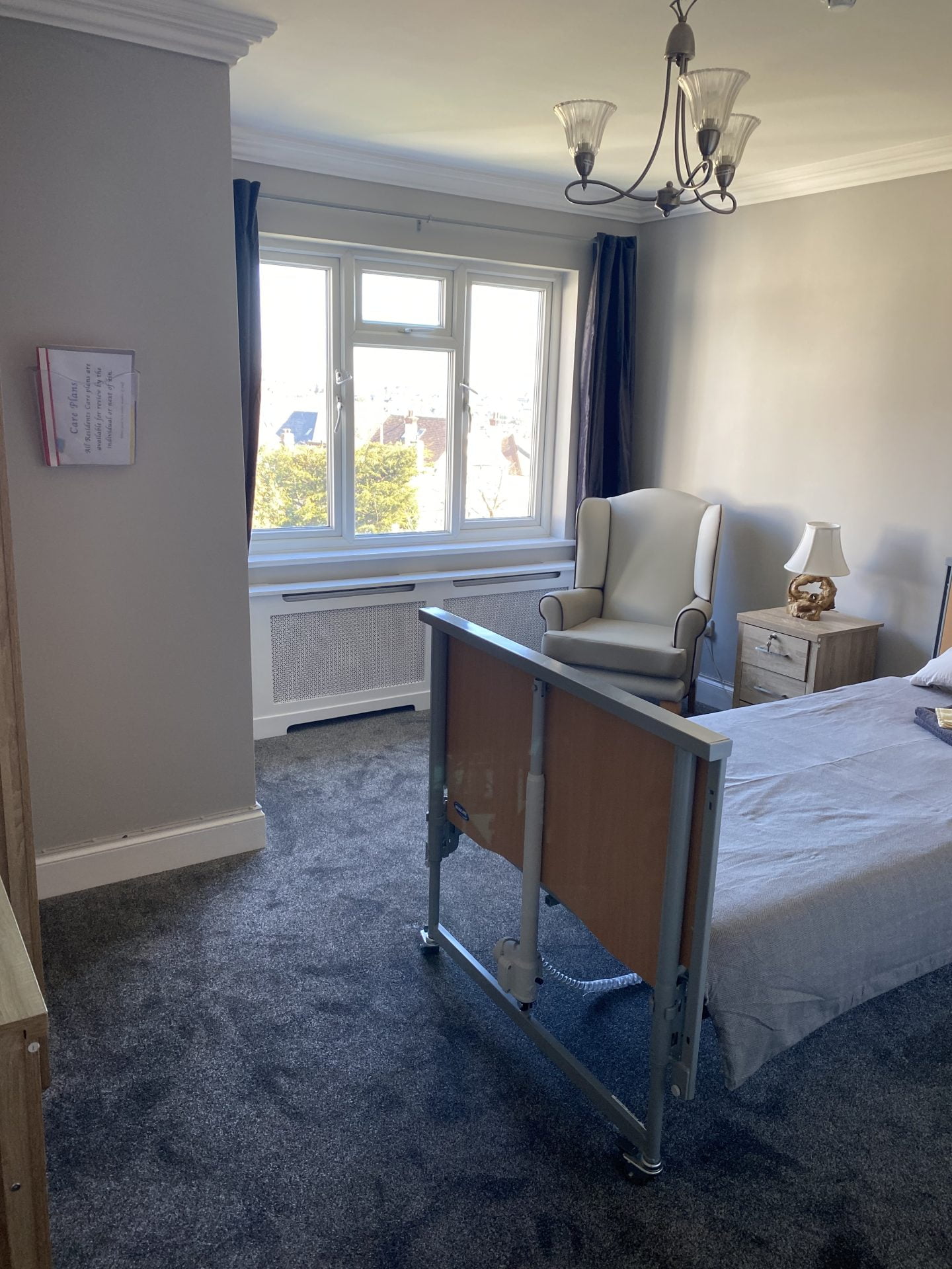 Private resident room with bed and armchair