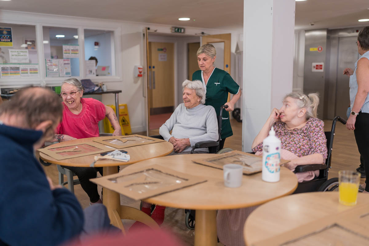 Residents and staff engaging in an activity.