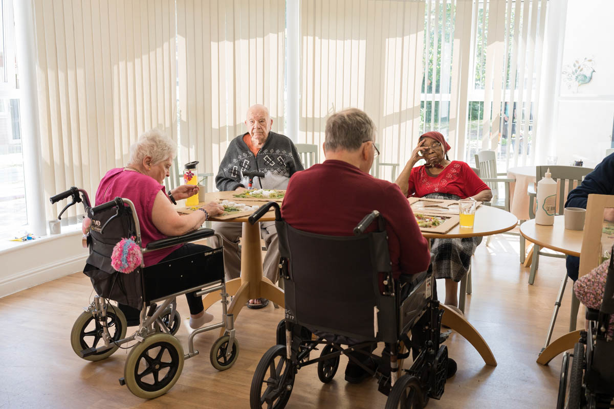 Residents enjoying a meal in a dining area