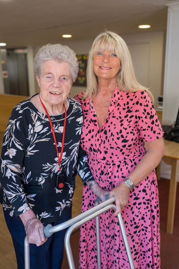 Resident and staff member in a common area