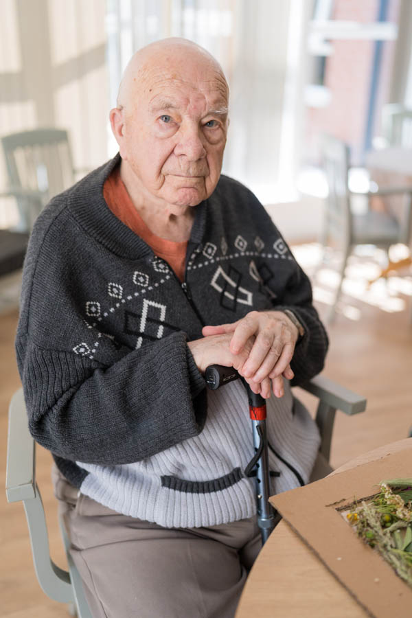 Elderly man sitting in a social area.