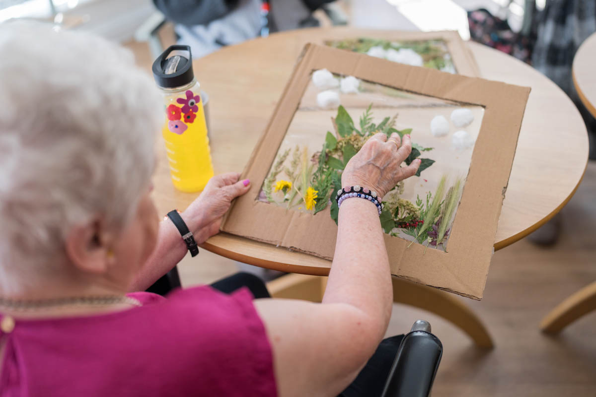 Senior resident creating art activity