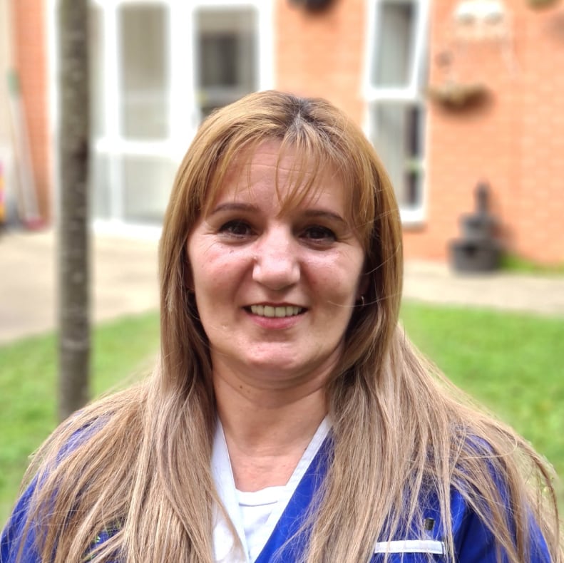 Staff member smiling outdoors at Beechdale Manor Care Home