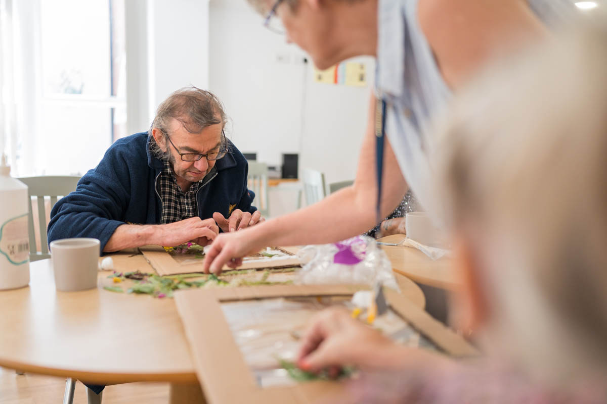 Residents engaged in an art activity together.