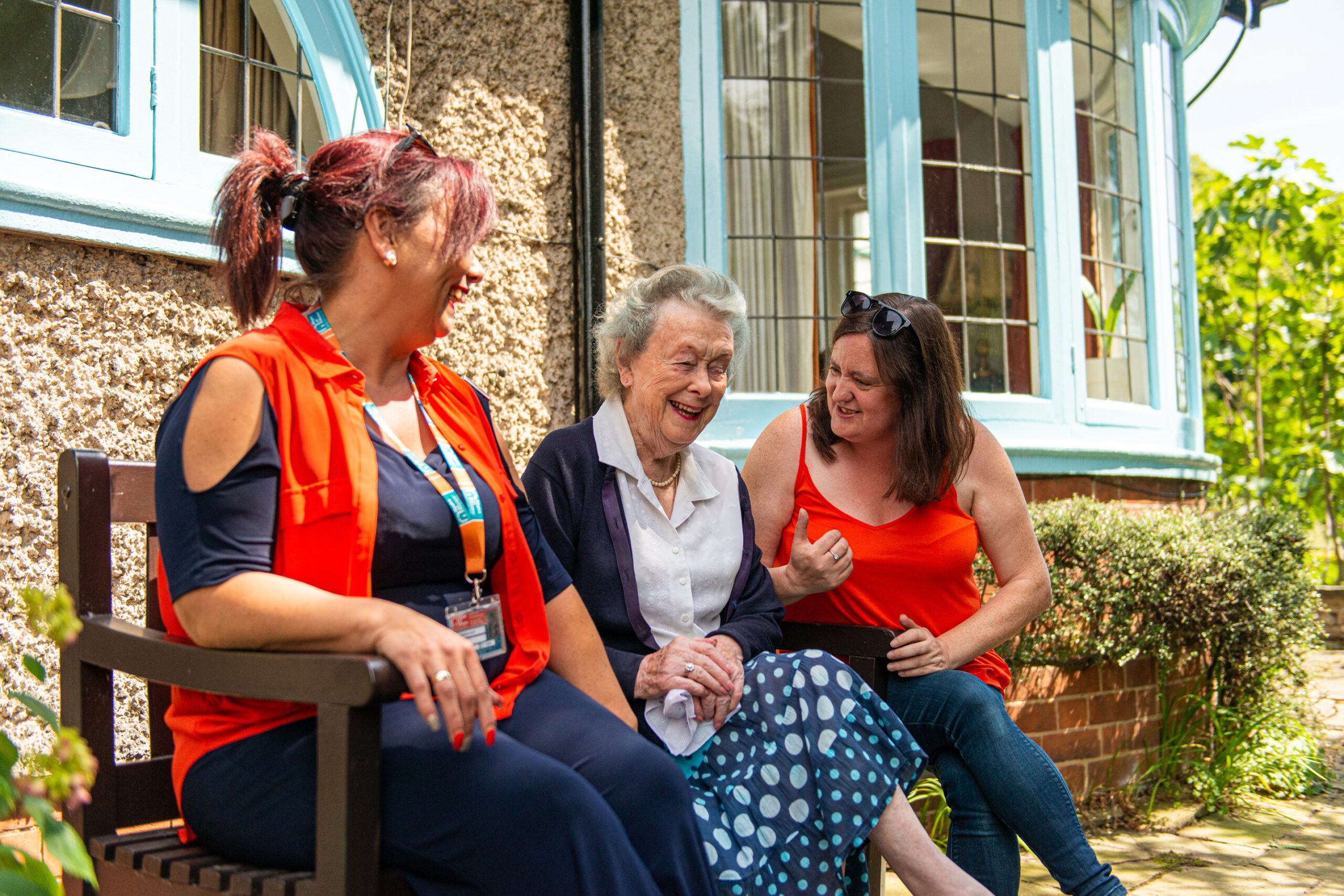 Staff and resident enjoying conversation outdoors