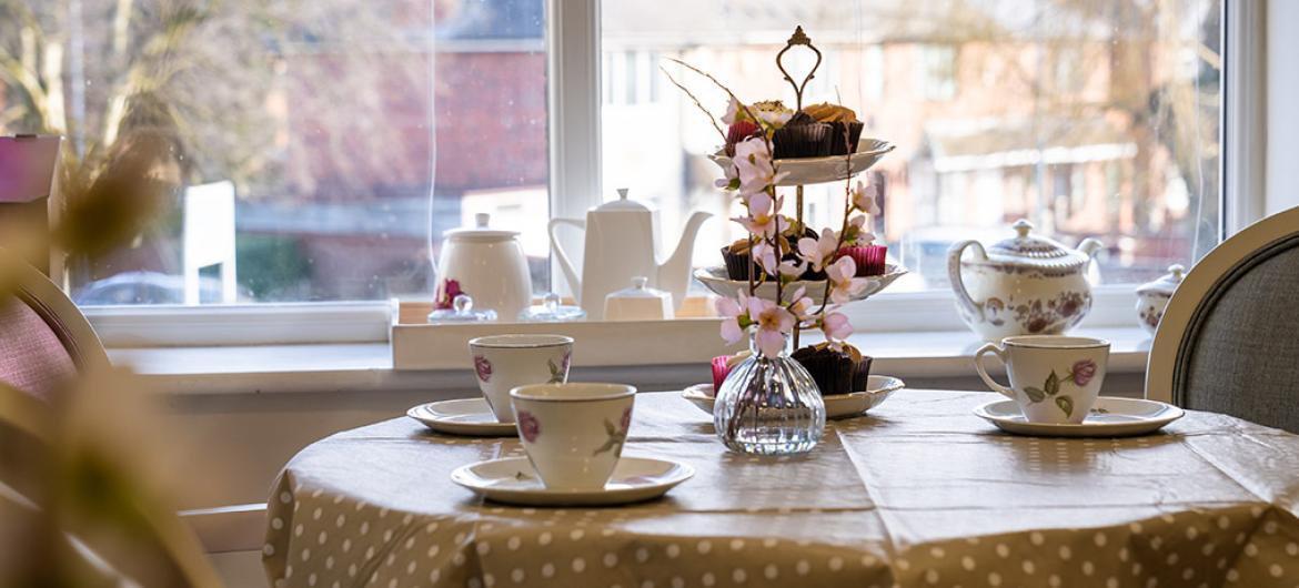 Table set for tea with floral decorations.