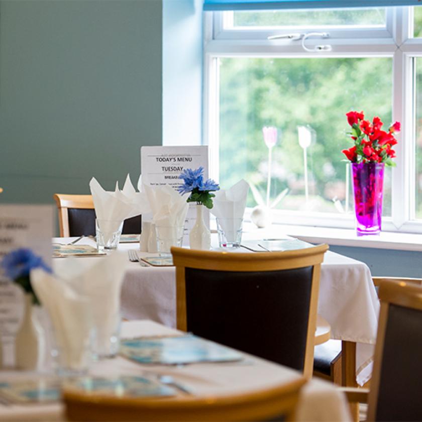 Dining area with set tables and flowers